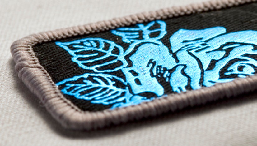 Foil printed twill patch with serged edge