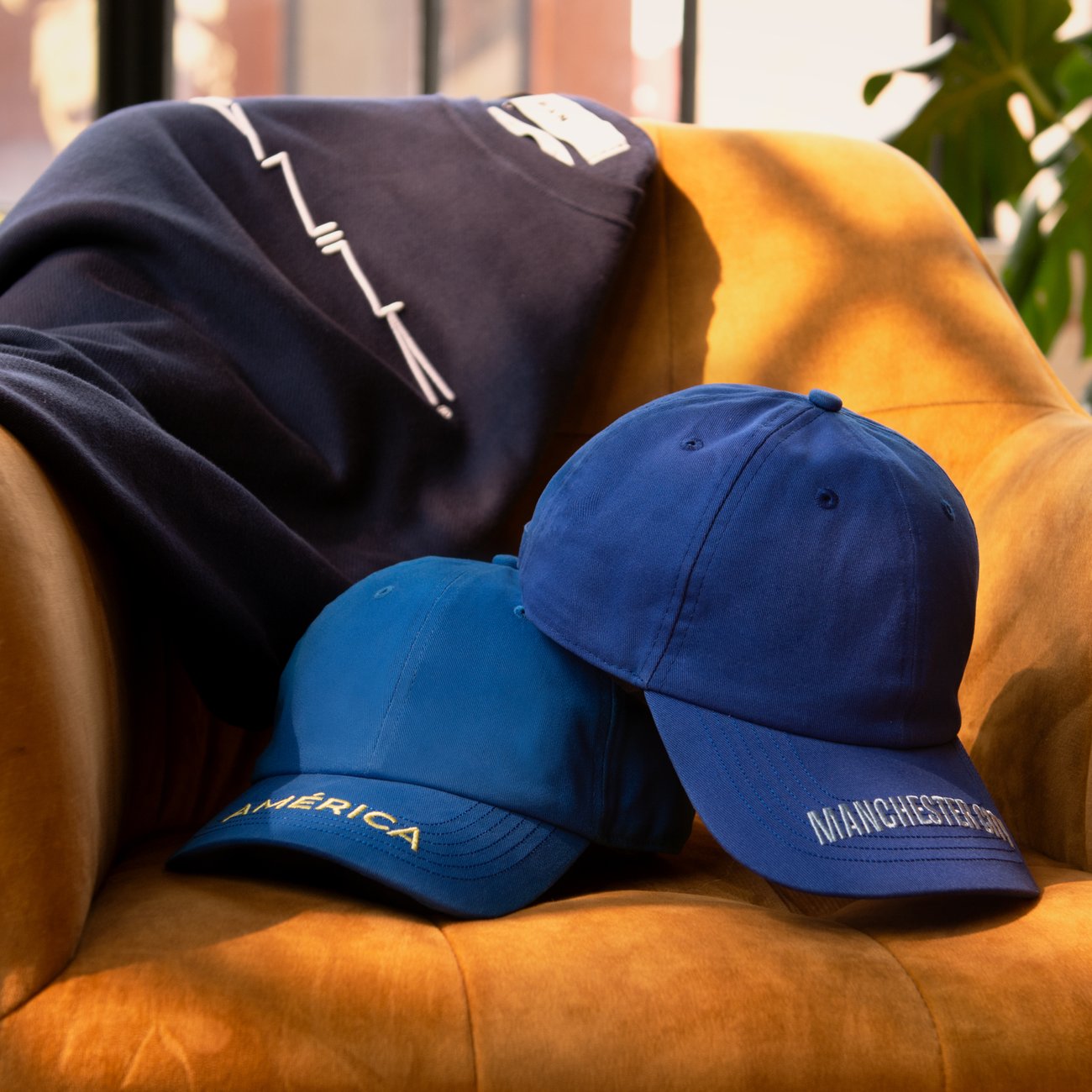 Two washed cotton twill caps with embroidered peaks
